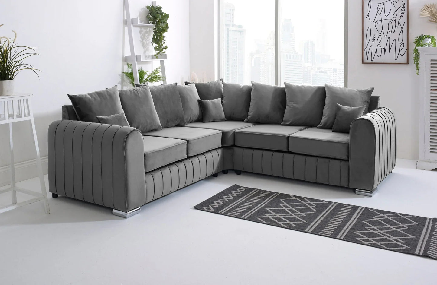 Gray sectional sofa in a living room with a rug and decor elements.