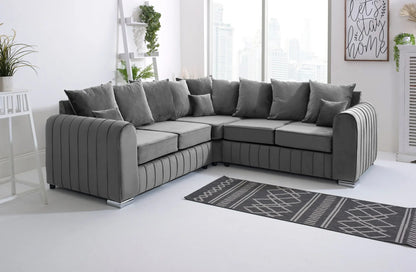 Gray sectional sofa in a living room with a rug and decor elements.