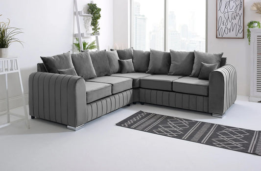 Gray sectional sofa in a living room with a rug and decor elements.
