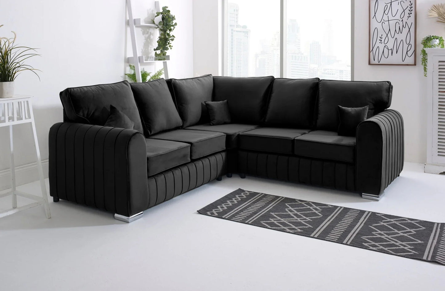 Black Lily High Back sofa in a modern living room with a rug and decor elements.