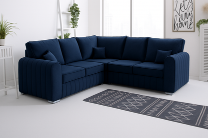 Navy blue High Back  sofa in a room with a rug and plants.