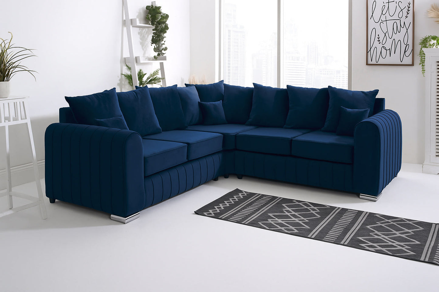 Navy blue sectional sofa in a living room with a rug and plants.