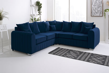Navy blue sectional sofa in a living room with a rug and plants.