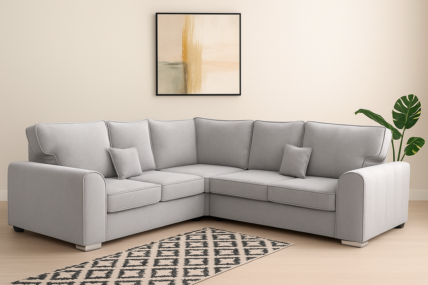 Gray sectional sofa in a living room with a patterned rug and abstract painting.