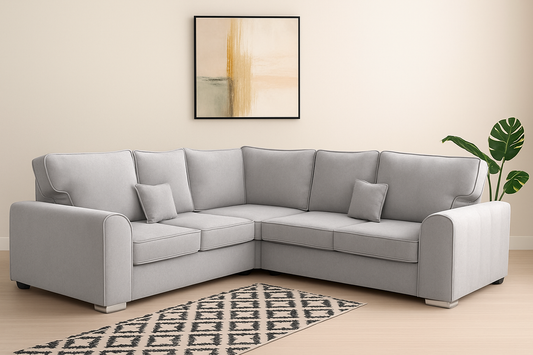 Gray sectional sofa in a living room with a patterned rug and abstract painting.