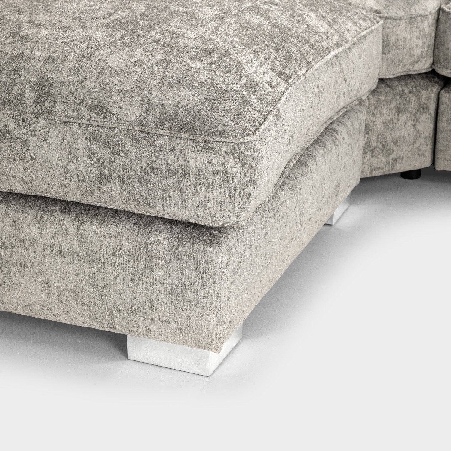 Close-up of a textured gray sofa corner on a white background