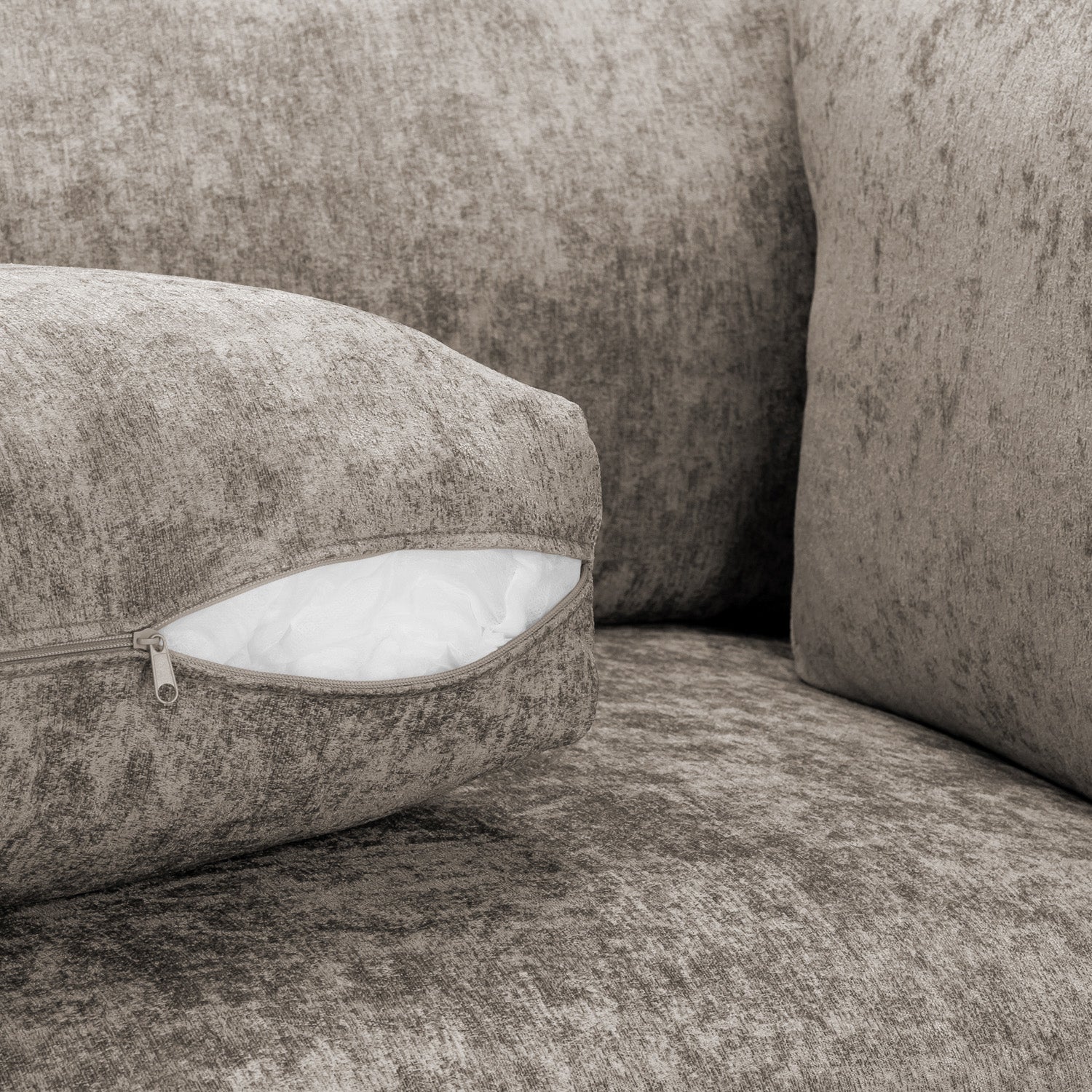 Gray textured sofa with a cushion and white filling visible
