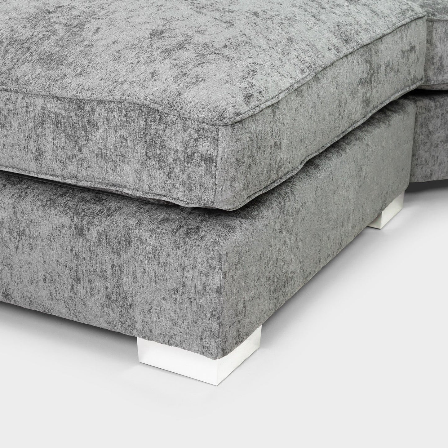 Gray upholstered corner piece on a white background