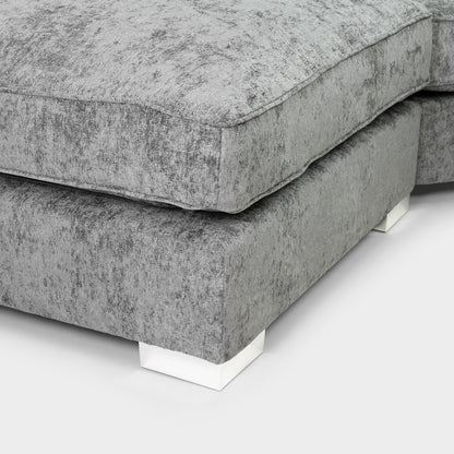 Gray upholstered corner piece on a white background