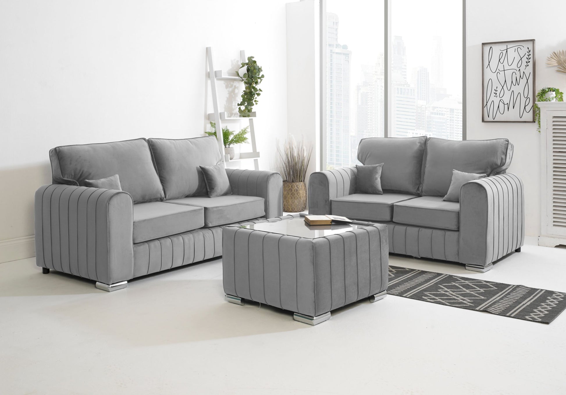 Gray sofa set in a living room with a coffee table and decorative items.