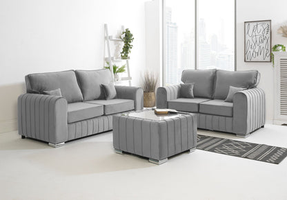 Gray sofa set in a living room with a coffee table and decorative items.