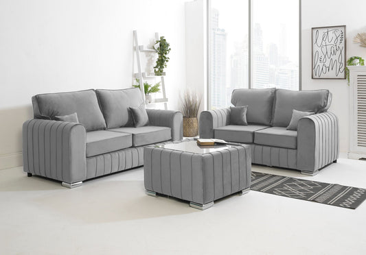 Gray sofa set in a living room with a coffee table and decorative items.